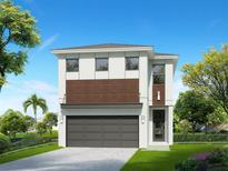 Two-story home with modern design, attached garage, and landscaping at 1535 Corolla Ct, Reunion, FL 34747