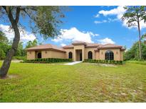 Single-story home with a tile roof and a manicured lawn at 2051 Lorene Ln, Deltona, FL 32738