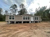 Single wide manufactured home on a dirt foundation at 18955 Se 107Th Pl, Ocklawaha, FL 32179