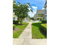 Inviting walkway through a charming community with manicured lawns at 2606 Lodi Cir # 105, Kissimmee, FL 34746