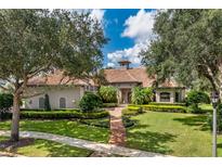 Luxury home with tile roof, landscaping, and walkway at 11261 Macaw Ct, Windermere, FL 34786