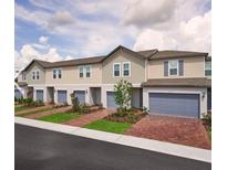 Row of townhouses with attached garages and landscaping at 2021 Crape Jasmine Ln, Orlando, FL 32824