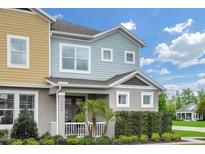 Two-story townhome with light blue and yellow siding at 1455 Alston Bay Blvd, Apopka, FL 32703