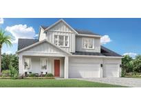 Two-story home with a two-car garage and modern farmhouse style at 1413 Pinecliff Dr, Apopka, FL 32703