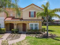 Two-story townhome with red shutters and a landscaped yard at 4791 Terrasonesta Dr, Davenport, FL 33837