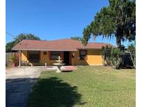 Ranch style home with mature landscaping and a fountain at 709 N Disston, Tavares, FL 32778