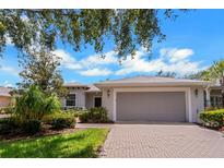 Front view of a single-story house with a two-car garage at 316 Shelbourne Loop, Kissimmee, FL 34759