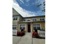 Front view of charming townhome with white picket fence at 4000 Santa Maria Dr # 105, Kissimmee, FL 34741