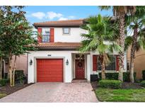 Two-story house with red door and shutters at 5431 Solterra Cir, Davenport, FL 33837