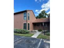 Two-story condo with Spanish tile roof and landscaped entry at 663 Trinidad Ct # S, Winter Park, FL 32792