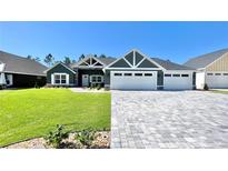 Beautiful two-story home with a three-car garage and well-manicured lawn at 6425 Sw 180Th Cir, Dunnellon, FL 34432