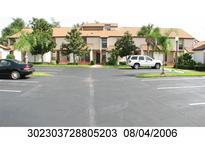 Building exterior with parking lot and landscaping at 2909 Clubview # 2909, Orlando, FL 32822