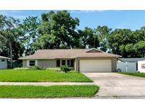 Single-story home with a two-car garage and lawn at 528 Ridgewood St, Altamonte Springs, FL 32701