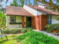 Brick front of charming home with lush landscaping and a welcoming entrance at 4037 W Maryland Pl, Casselberry, FL 32707