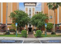 Condo building exterior with landscaping and parking at 12527 Floridays Resort Dr # 312-E, Orlando, FL 32821