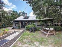 Quaint house exterior with a charming front yard and patio at 1079 Marion St, Lake Helen, FL 32744