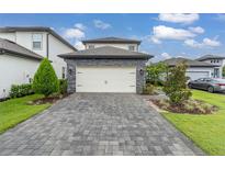 Two-car garage with paver driveway at 1409 Bellamy Dr, Reunion, FL 34747
