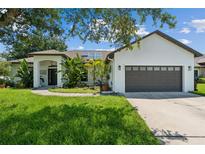 Single-story home with a two-car garage and solar panels at 4901 Culdesac Ct, St Cloud, FL 34772