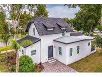 Modern two-story house with gray door and landscaping at 732 E Orange Ave, Eustis, FL 32726