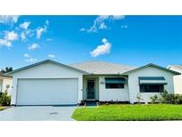 White single story home with a two car garage and landscaped lawn at 4901 Pleasant Hollow Trl, Lakeland, FL 33811
