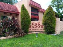 Oak Shadow Condominium entrance with landscaping and signage at 2860 N Powers Dr # 133, Orlando, FL 32818