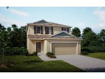 Two-story house with a beige exterior and a two-car garage at 1701 Andover Ridge Dr, Deland, FL 32720