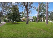 Charming house with a spacious front yard and mature trees at 731 Midget Dr, Winter Park, FL 32789