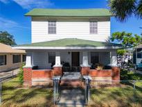 Two-story house with green roof and brick facade at 610 S Laurel Ave, Sanford, FL 32771