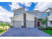 Modern two-story home with two-car garage and paver driveway at 951 Splash Shot Pl # 0, Davenport, FL 33896