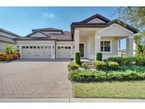 Two-story home with a two-car garage and landscaped yard at 10951 Citron Oaks Dr, Orlando, FL 32836