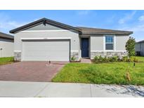 Two-car garage and a well-maintained lawn at 2482 Leeds St, Haines City, FL 33844