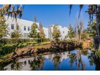 Modern white building with waterfront views and lush landscaping at 1806 Mondrian Cir, Winter Park, FL 32789