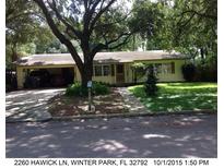 Ranch-style home with carport, mature trees, and well-maintained lawn at 2260 Hawick Ln, Winter Park, FL 32792