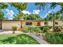 House exterior with landscaped yard and brick pavers at 1123 Waltham Ave., Belle Isle, FL 32809