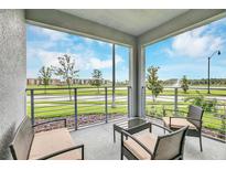 Spacious balcony with water views and comfortable seating at 4721 Clock Tower Dr # 108, Kissimmee, FL 34746