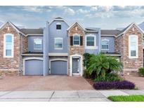 Stunning three-story townhome with stone accents and two-car garage at 2286 Chatham Place Dr, Orlando, FL 32824