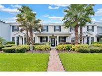 Front view of charming townhome with landscaping at 11918 Sonnet Ave, Orlando, FL 32832