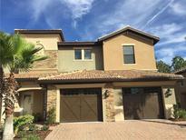 Two-story townhome with double garage and stone accents at 8975 Azalea Sands Ln, Davenport, FL 33896