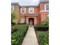 Two-story home with welcoming walkway and landscaping at 8531 Bay Lilly Loop, Kissimmee, FL 34747