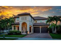 Two-story house with a brick driveway and landscaping at 11823 Otterbrooke Trl, Windermere, FL 34786