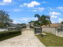 Two-car garage home with a well-maintained lawn at 112 Winterglen Dr, Sanford, FL 32771
