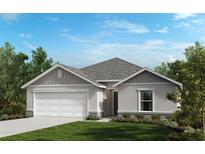 One-story home with gray siding and a two-car garage at 3474 Narrows Dr, Lakeland, FL 33810