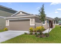 One-story home with two-car garage and landscaped yard at 607 Alder Ln, Auburndale, FL 33823