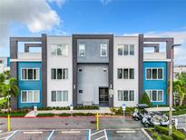 Modern building exterior with blue and gray accents, and a golf cart at 7740 Sandy Ridge Dr # 100, Reunion, FL 34747
