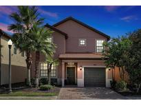 Two-story house with a gray door and brown roof at 5424 Solterra Cir # 1, Davenport, FL 33837