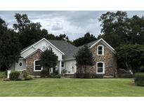 Two-story house with stone facade and manicured lawn at 3820 Oak Pointe Dr, Lady Lake, FL 32159