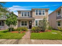 Two-story home with neutral exterior and landscaping at 8217 De Haven Street, Orlando, FL 32832