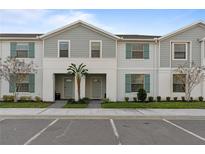 Modern two-story townhome with gray siding and teal shutters at 2428 Dubai St, Kissimmee, FL 34747