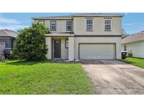 Two-story house with gray siding, double car garage, and manicured lawn at 2548 Lyndscape St, Orlando, FL 32833