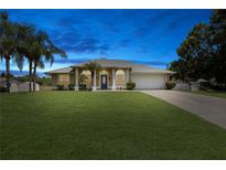 Single-story house with lawn and driveway at dusk at 1053 Abadan Dr, Deltona, FL 32725